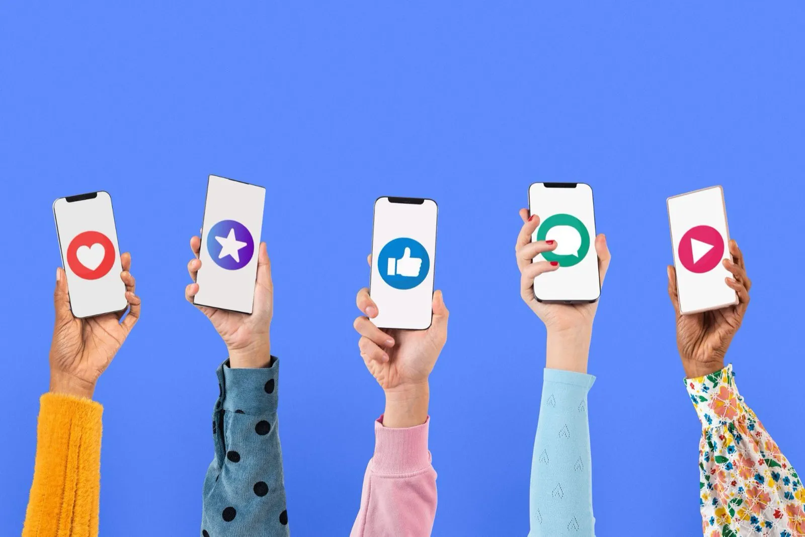 Five raised hands holding phones displaying social media reaction icons